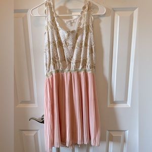 Short sleeveless dress. White w/gold embellishments with pink on bottom. Medium